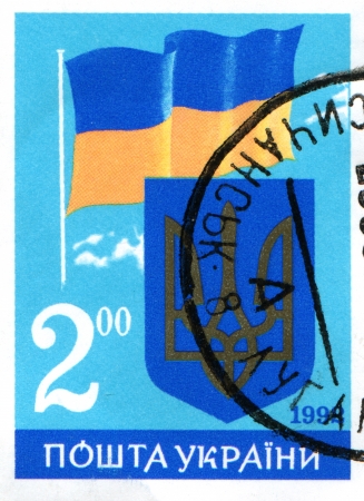 UKRAINE - CIRCA CIRCA 1992  A stamp printed in Ukraine shows coat of arms and flag of Ukraine, circa 1992の写真素材
