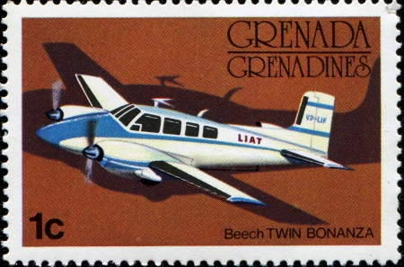GRENADA - CIRCA 1976  A stamp printed in Grenada showing Beech Twin Bonanza airplane, circa 1976のeditorial素材