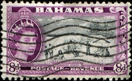 BAHAMAS - CIRCA 1954  A stamp printed in Bahamas shows Queen Elizabeth II and peoples on the beach, circa 1954のeditorial素材