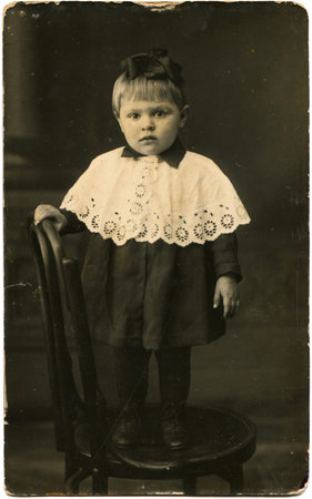 portrait of little girl in a dress and embroidered cape, USSR, 1932