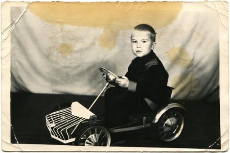 USSR - CIRCA 1960s  The little boy on the pedal car, circa 1960sのeditorial素材