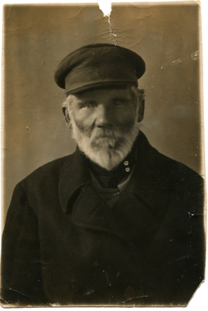 RUSSIA - CIRCA 1920s  Portrait of an elderly man with a gray beard in a dark coat and cap, circa 1920sのeditorial素材