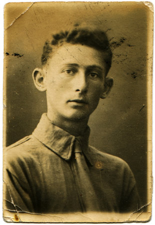 RUSSIA - CIRCA 1938  Portrait of a young man in a gray shirt and tie, circa 1938