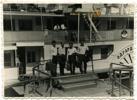 USSR - CIRCA 1960s  Picture reproduction was made in the USSR shows a group of four men in the background of a recreational ship, about 1960s, the Russian text - Edwardのeditorial素材
