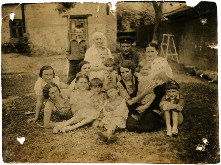 USSR - CIRCA 1930s  Officer of the Red Army sitting in the courtyard surrounded by women and children, circa 1930sのeditorial素材