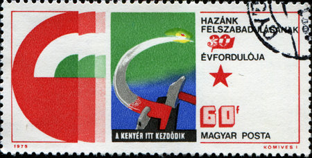 HUNGARY - CIRCA 1975  A stamp printed in  Hungary honoring 30th Anniversary of Liberation, shows Hammer and sickle representing agriculture , circa 1975 のeditorial素材