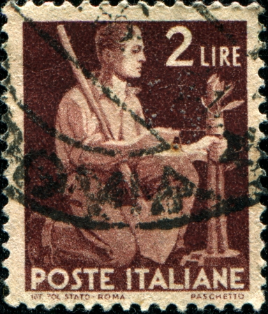 ITALY - CIRCA 1953  A stamp printed in Italy shows a man kneeling, series, circa 1953 のeditorial素材