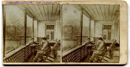RUSSIA - CIRCA 1913  An antique photo shows stereo, a man with a boy playing checkers on the porch at home, the Russian Empire, 1913Russian text  quandaryのeditorial素材