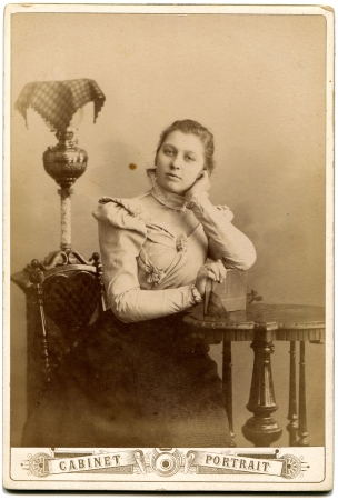 RUSSIA - CIRCA  the end of 19 - early 20century  An antique photo shows girl sitting near a table, based on the book, the Russian Empireのeditorial素材