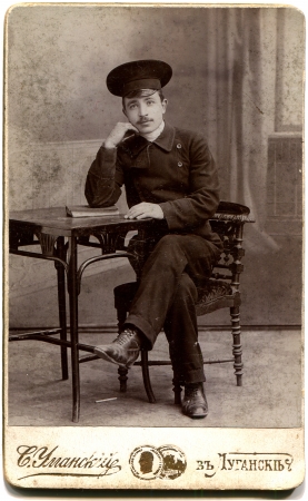 RUSSIA - CIRCA  the end of 19 - early 20century  An antique photo shows young man in uniform seating...