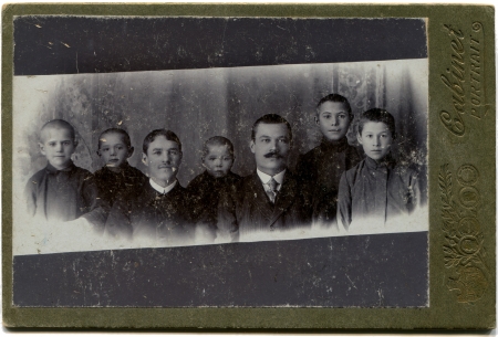 RUSSIA - CIRCA  the end of 19 - early 20 century  An antique photo shows Two men with five boys, the...