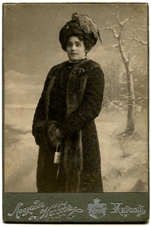 RUSSIA - CIRCA  the end of 19 - early 20 century  An antique photo shows woman in a fur coat and hat with a clutch in their hands, Kherson, Russian EmpireRussian text  Leonid Koff  photographer , Khersonのeditorial素材