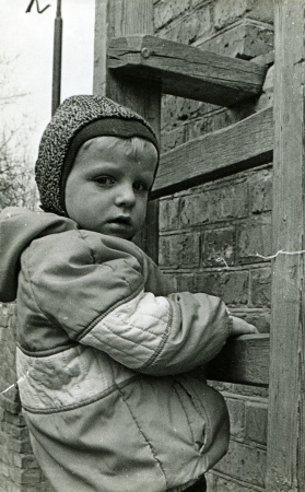 little boy climbs the wooden stairs, mounted on a brick wall, Kamensk Shakhtinsky, Rostov Region, USSR, 1980の写真素材
