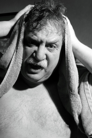 middle-aged man with a towel out of the bathroom の写真素材