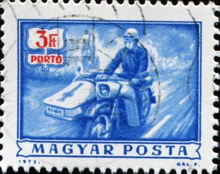  HUNGARY - CIRCA 1973  A stamp printed in Hungary shows postman on motorbike, circa 1973 のeditorial素材