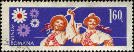 ROMANIA - CIRCA 1968: A stamp printed in  Romania shows Young Pioneers, Folk-dancing , circa 1968 のeditorial素材