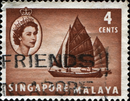 SINGAPORE - CIRCA 1955  A stamp printed in Singapore and Malaya showTwa-kow lighter , circa 1955のeditorial素材