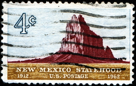 USA - CIRCA 1962  A stamp printed in the United States of America issued for the 50th anniversary of Statehood of New Mexico shows Shiprock, circa 1962の写真素材