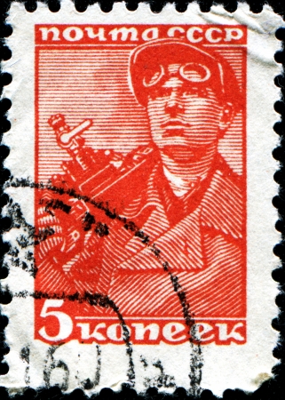 USSR - CIRCA 1929  A post stamp printed in USSR shows miner, circa 1929のeditorial素材