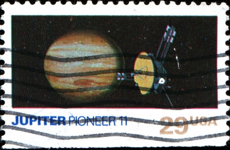 USA - CIRCA 1991  A stamp printed in United States of America shows Jupiter and Pioneer 11, circa 1991のeditorial素材