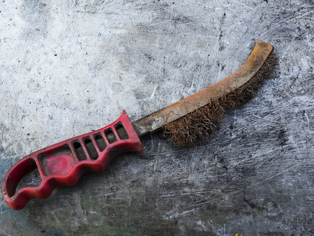 Old rusty brass brush on metal backgroundの写真素材