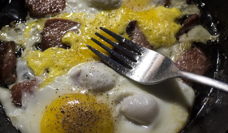 Scrambled eggs with bacon in a frying panの写真素材