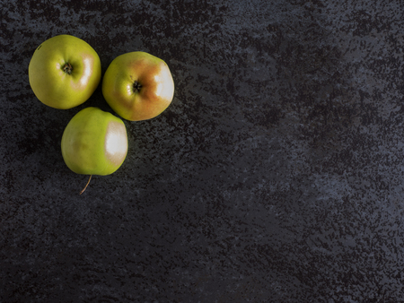 Top view of green apples on a black stone tableの写真素材