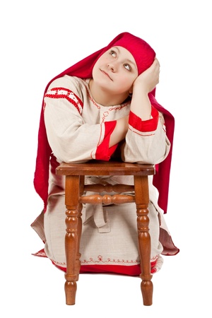 Pretty russian girl dressed in national costume posing over whiteの写真素材