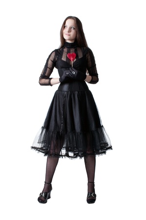 Gothic girl with lollipop isolated over whiteの写真素材