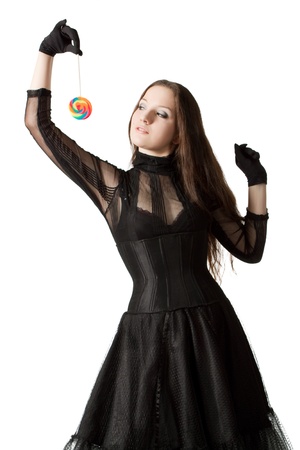 Gothic girl with lollipop over white backgroundの写真素材