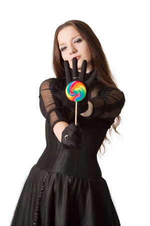 Gothic girl with lollipop isolated over whiteの写真素材