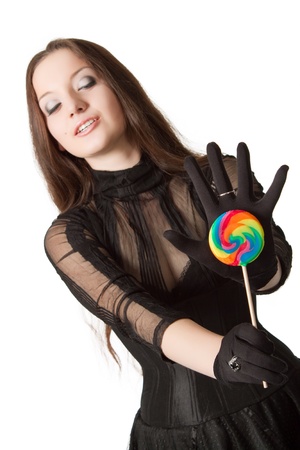 Gothic girl with lollipop. Isolated over white. Focus on lollipop.の写真素材