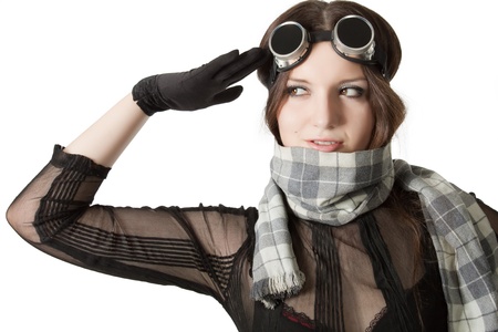 Prety pilot in scarf and googles saluting over whiteの写真素材
