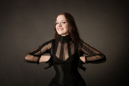 Funny positive gothic girl posing over grayの写真素材