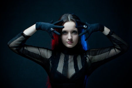 Pretty enchantress posing over darkの写真素材