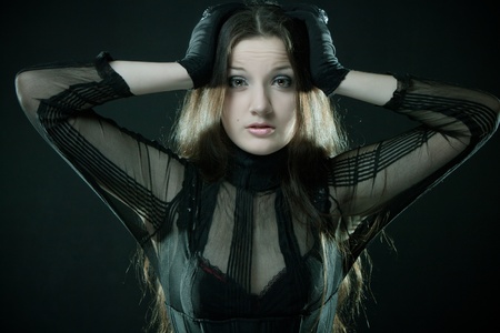 Surprised girl posing over black background