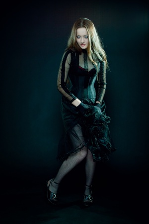 Pretty gothic girl dancing over dark backgroundの写真素材