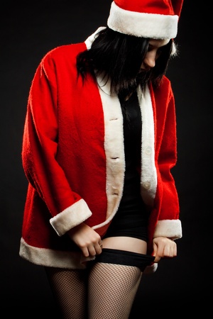 Sexy Santa's helper in panty hose posing over dark backgroundの写真素材