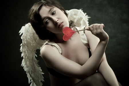 Sad pretty angel with lollipopの写真素材