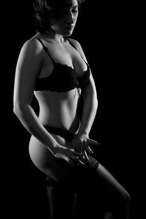 pretty sexy girl in underwear posing over dark backgroundの写真素材