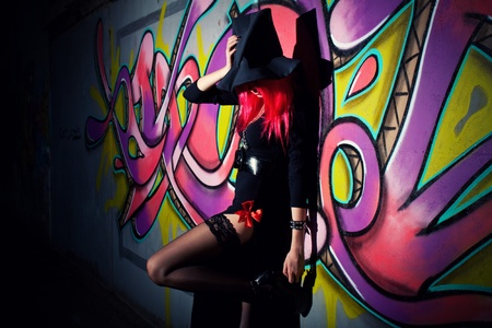 pretty redhead witch posing over wallの写真素材