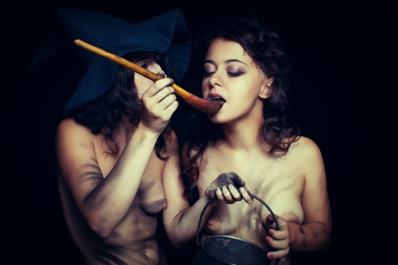 Two sexy dirty nude witch having a breakfastの写真素材