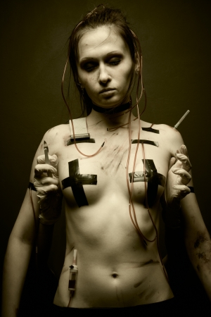 Pretty durty cyberpunk girl posing over dark backgroundの写真素材