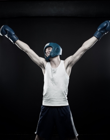 Young boxer posing over dark backgroundの写真素材
