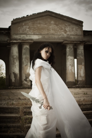 Pretty gothic girl posing with swordの写真素材