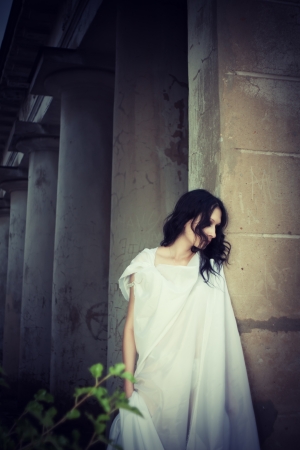 Pretty gothic girl on an old cemeteryの写真素材