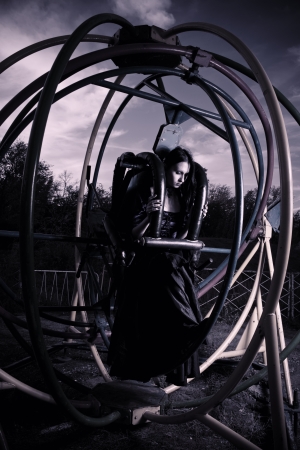 Gothic girl sitting in bizzare dream machine の写真素材