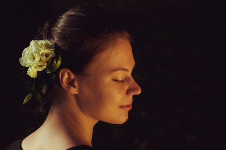 Pretty young woman with flowers in her hairsの写真素材