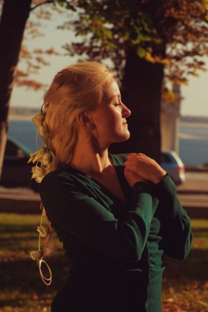 Pretty young girl with flowers in her hairsの写真素材