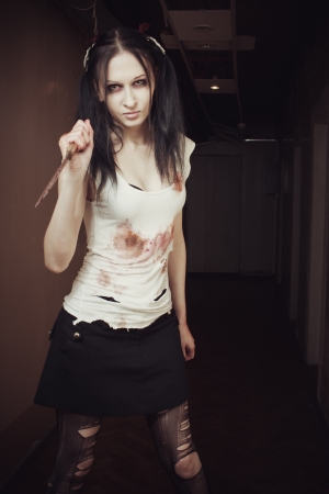 Seductive maniac girl with bloody knifeの写真素材